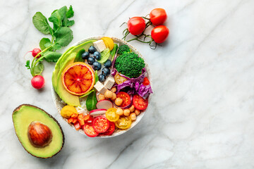Buddha Bowl. Rainbow salad. Vegan poke bowl with avocado. Healthy food. Overhead flat lay shot with ingredients and copy space