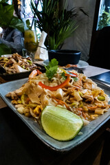 Pad Thai, traditional noodles, sauteed with chicken, shrimp, and vegetables, at a restaurant