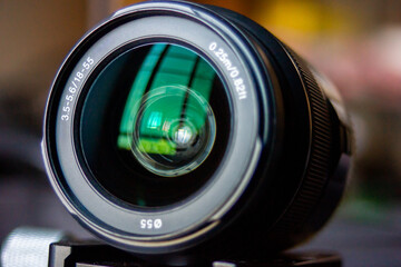 camera lens kit 18-55mm f3.5-5.6 have filter size 55 mm in blur background with reflex of the...