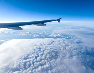 Obraz premium Aerial View Of Airplane Wing Over Fluffy Cloudscape