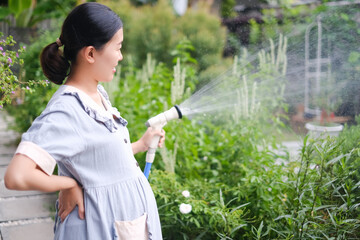 pregnant asian woman relax in garden