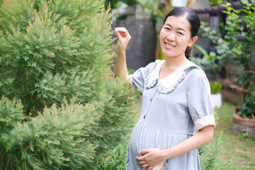 pregnant asian woman in the garden