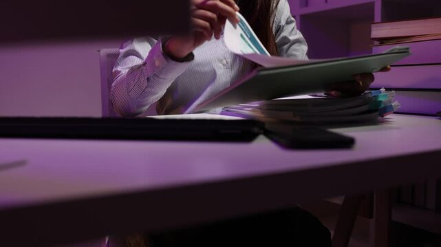 a businesswoman works late into the night because she has to deal with important contract documents that ned to be presented tomorrow, one of the employees worked overtime