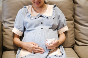 Pregnant woman holding a white java sparrow in her hands