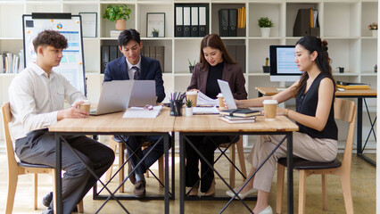 Business team in a creative workspace reviewing data and brainstorming during a team meeting.