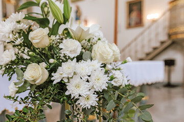 Flowers and Green Branches Adorning Church Interior for First Holy Communion Mass
