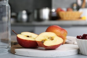 Tasty apples and cherries on light grey table, closeup