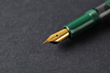 One fountain pen on dark background, macro view. Space for text