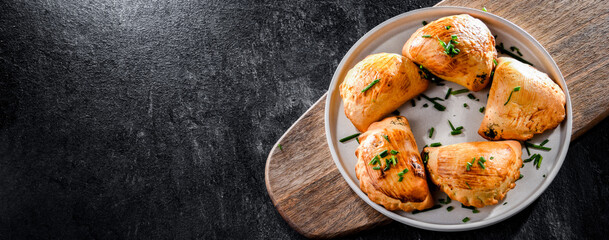 Composition with a plate of oven-baked pierogi