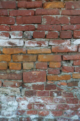 Old distressed vintage wall bricks background with cracked cement