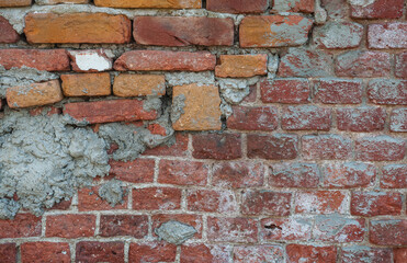 Obraz premium Old distressed vintage wall bricks background with cracked cement