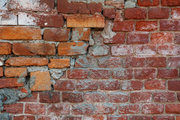 Old distressed vintage wall bricks background with cracked cement