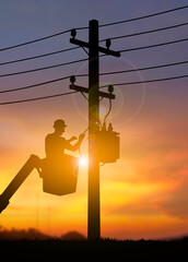 Electrician Working on Power Lines at Sunset