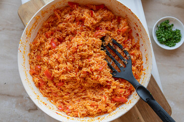 Homemade fresh cooked bell pepper rice with ajvar in a frying pan