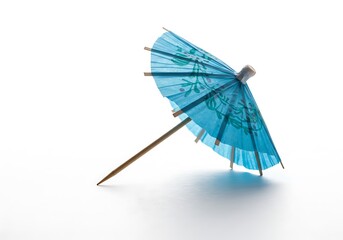 A single blue cocktail umbrella with floral design on a white background casting a soft shadow below it
