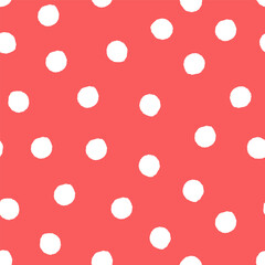 Seamless polka dot pattern with irregular white circles on coral red background.