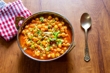 Kabuli Chana Masala is a flavorful North Indian curry made with chickpeas, tomatoes, onions, and aromatic spices, simmered to a rich, hearty consistency.
