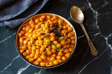 Kabuli Chana Masala is a flavorful North Indian curry made with chickpeas, tomatoes, onions, and aromatic spices, simmered to a rich, hearty consistency.
