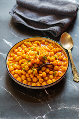 Kabuli Chana Masala is a flavorful North Indian curry made with chickpeas, tomatoes, onions, and aromatic spices, simmered to a rich, hearty consistency.
