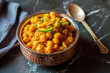 Kabuli Chana Masala is a flavorful North Indian curry made with chickpeas, tomatoes, onions, and aromatic spices, simmered to a rich, hearty consistency.
