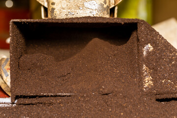 Ground coffee in the electric grinder