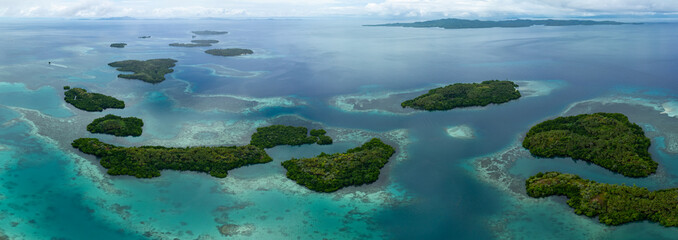 Healthy coral reefs fringe the idyllic islands of Garacie, near Halmahera, Indonesia. This scenic, biodiverse area lies between Sulawesi and Raja Ampat. It is a destination for divers and snorkelers.