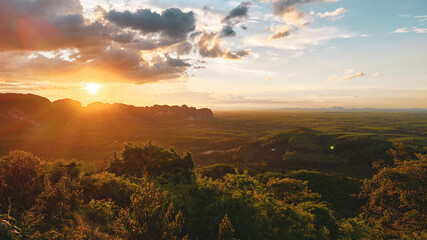 Golden Hour Landscape: Witness the breathtaking landscape as the sun dips towards the horizon. An ethereal atmosphere bathed in warm sunlight and dramatic clouds, offering a sense of awe.