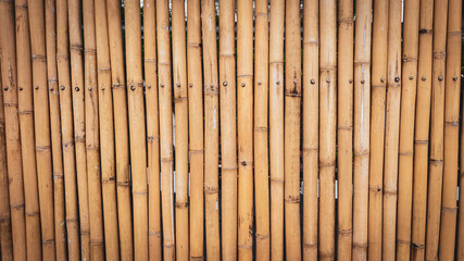 Bamboo Fence: A meticulously arranged display of bamboo poles creates a compelling natural fence,...