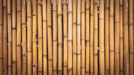 Textured Bamboo: An organic wall of warm, golden-brown bamboo poles creates a natural and inviting textural backdrop.