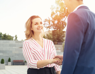 Handshake between a man and a woman. Business meeting.