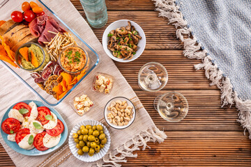 Tray with appetizers and wine for a picnic, outdoor eating