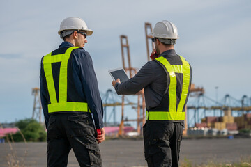 Industrial engineer workers operations marine port cranes loading and unloading of cargo ships...