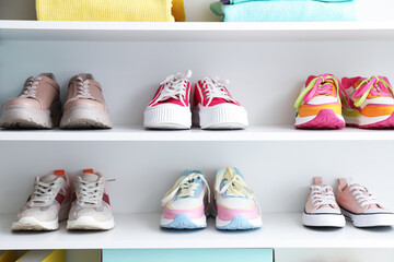Fototapeta na wymiar Different footwear on shelves indoors. Shoe storage