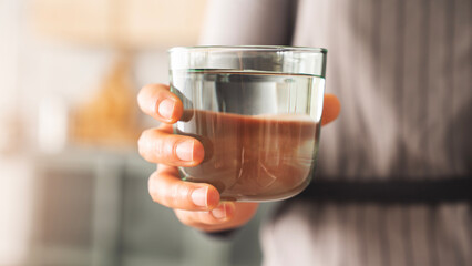 Woman holding a glass of drinking water
