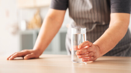 Woman holding a glass of drinking water