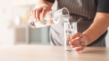 Woman holding a glass of drinking water