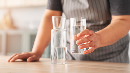 Woman holding a glass of drinking water
