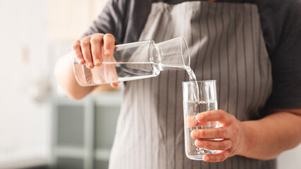 Woman holding a glass of drinking water