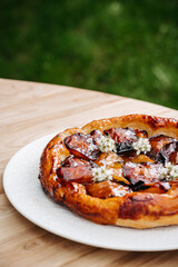 Homemade rustic fruit galette prepared outdoors.