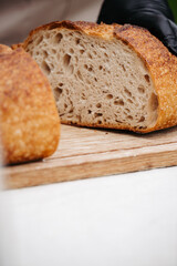 Fresh rustic sourdough bread on cutting board.