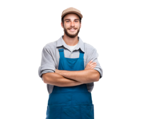 A smiling, confident man with a beard wearing a cap and blue overalls poses with arms crossed.