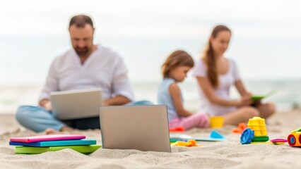 Family working and playing on the beach with laptops and toys.