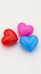 Obraz premium A close up of three hearts on a white surface.
