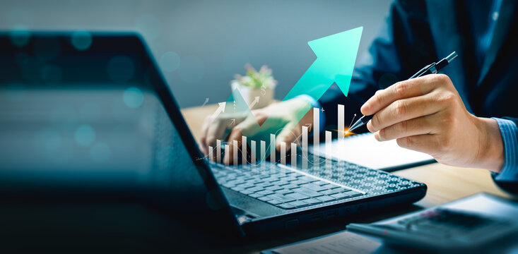 Business growth and financial success concept with rising graph and futuristic analytics. Businessman using digital pen and tablet for data-driven strategy, smart investment, and performance planning.