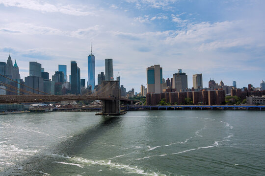Brooklyn Bridge spans East River with backdrop of Manhattan skyline at NYC America