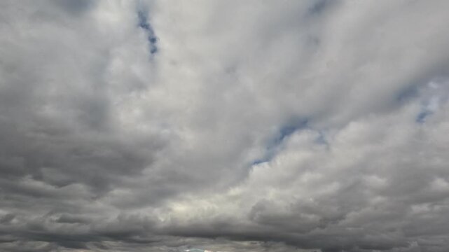 Incredibly beautiful grey cumulus textured clouds under blue sky on partly cloudy day. Timelapse mode.