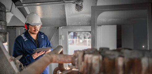 Engine engineer inspecting large machines in factory,Railway engine maintenance technician,engine repair mechanical manager