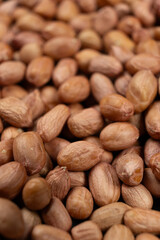 Peanut background, lots of raw peeled brown peanuts close-up.