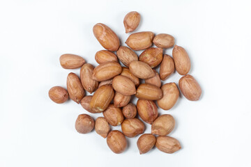 Raw brown peanuts macro view from above on white background