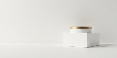 A minimalist product display featuring a white cylindrical container with a gold lid atop a pristine white cube against a stark white backdrop.